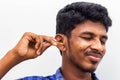 Remove Ear wax Safely - Man cleaning ear with cotton swabs closeup shot. Cleaning ear with cotton bud Dirty ear. Removing ear wax