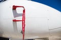 remove before flight flag cover pitot static tube of white aircraft at parking area Royalty Free Stock Photo