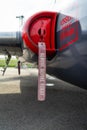 A remove before flight ribbon on a jet airplane.