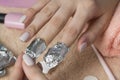 Remove the gel polish with foil. Woman pours remove liquid on a cotton pad, puts it on a nail and wraps the foil. Removing shellac Royalty Free Stock Photo