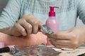 Remove the gel polish with foil. Woman pours remove liquid on a cotton pad, puts it on a nail and wraps the foil. Removing shellac Royalty Free Stock Photo