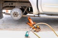 Remove wheel by car jack for repair with tool.