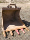 Removed rusty excavator bucket is located in a quarry