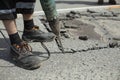 He removes the asphalt with a jackhammer. Removing the asphalt layer from the road