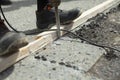 He removes the asphalt with a jackhammer. Removing the asphalt layer from the road