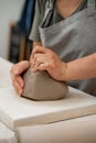 Removing air bubbles from clay before modeling to avoid the ruination of a ceramic product. Wedging the clay before Royalty Free Stock Photo