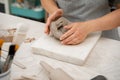Removing air bubbles from clay before modeling to avoid the ruination of a ceramic product. Wedging the clay before Royalty Free Stock Photo