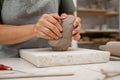 Removing air bubbles from clay before modeling to avoid the ruination of a ceramic product. Wedging the clay before Royalty Free Stock Photo