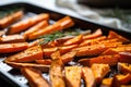 removing baked sweet potato fries from the oven