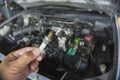 Removing car spark plugs at garage Royalty Free Stock Photo