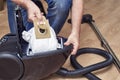 Removing full dust bag from a vacuum cleaner Royalty Free Stock Photo