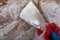 Removing mildew from the brick wall with a metal spatula. Small painting works at home Royalty Free Stock Photo