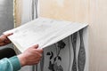 Removing old wallpaper from the wall. Royalty Free Stock Photo
