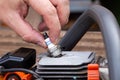 Removing the spark plug from the chainsaw cylinder. Replacing a new spark plug, a malfunction in the ignition of the