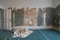 Removing wallpaper from wall in room during flat renovation Royalty Free Stock Photo