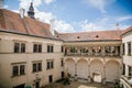 Renaissance chateau rebuilding of original Gothic castle with arcade in courtyard, colorful historical building on sunny summer