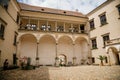 Renaissance chateau rebuilding of original Gothic castle with arcade in courtyard, colorful historical building on sunny summer