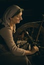 Peasant woman at spinning wheel