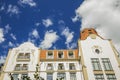 Renaissance palace medieval architecture palace exterior facade foreshortening from below on vivid blue sky fluffy white clouds ba