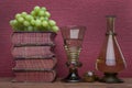 Renaissance, rummer wine glass, bottle, old books and grapes