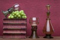 Renaissance, rummer wine glass, bottle, old books and grapes