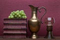 Renaissance, rummer wine glass, brass carafe, old books and grapes