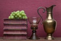 Renaissance, rummer wine glass, brass carafe, old books and grapes