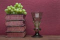 Renaissance, rummer wine glass, old books and grapes