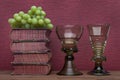 Renaissance, rummer wine glass, old books and grapes