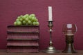 Renaissance, rummer wine glass, old books, grapes and candle holder