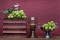 Renaissance, rummer wine glass, old books, tin cup and grapes Royalty Free Stock Photo