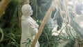 Renaissance statue of an ancient woman praying to God in a park