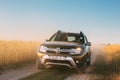 Renault Duster or Dacia Duster SUV in country road through summer