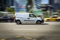 Renault Kangoo 2021 model LCV rides on the city road. White delivery van in motion