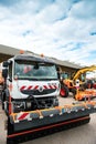 Renault truck snow plow with parked nearby Liebherr excavator