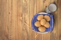 Eggs on blue towel in ceramic bowl on wooden table with glass of milk. Isolated on white background. Royalty Free Stock Photo