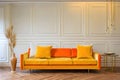 Modern living room interior with yellow orange sofa and white background Royalty Free Stock Photo