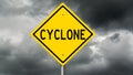 Yellow cyclone warning sign and dark clouds Royalty Free Stock Photo
