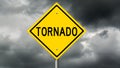 Yellow tornado warning sign and dark clouds Royalty Free Stock Photo