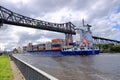 Rendsburg, Germany - August 22 2025: cargo ship pass beneath the Rendsburg High Bridge on the Kiel Canal Royalty Free Stock Photo