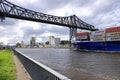 Rendsburg, Germany - August 22 2025: cargo ship pass beneath the Rendsburg High Bridge on the Kiel Canal Royalty Free Stock Photo