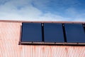 Renewable clean green energy saving efficient photovoltaic solar panels on multiple gable suburban house roof over blue sky Manche Royalty Free Stock Photo