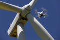 Drone hovering over wind turbines, renewable energy