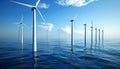 Renewable energy from offshore wind farm in vast blue ocean with white turbines under clear skies. Royalty Free Stock Photo