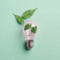 Renewable Energy and Sustainable Living concept depicted by a top view of an Eco-friendly lightbulb made of fresh leaves against a Royalty Free Stock Photo