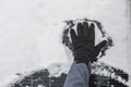 renewable energy in winter time. Getting electricity with solar panels in winter.Hands in black gloves clear snow from Royalty Free Stock Photo