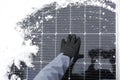 renewable energy in winter time. Solar energy panel in winter.electricity with solar panels in winter.Hands in gloves Royalty Free Stock Photo