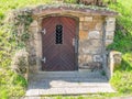 Renewal entrance door to an old historical basement, park landscape