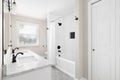 A bathroom with a white cabinet and grey hexagon tiled flooring. Royalty Free Stock Photo