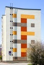 Renovated and insulated multistorey apartment building facade fragment against a blue sky background